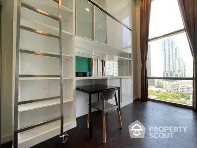 Bright and airy study with floor-to-ceiling windows offering a cityscape view, complemented by sleek white shelving and dark hardwood floors.