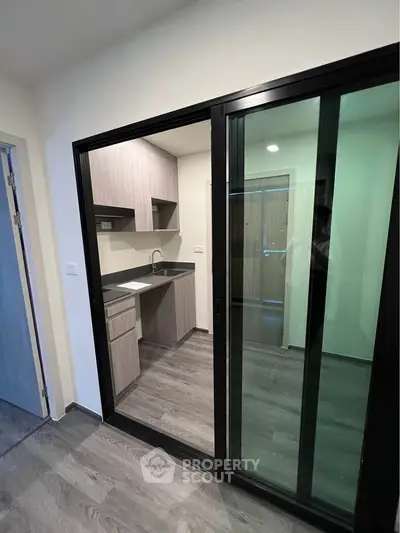 Modern kitchen with sleek closed layout and sliding glass doors