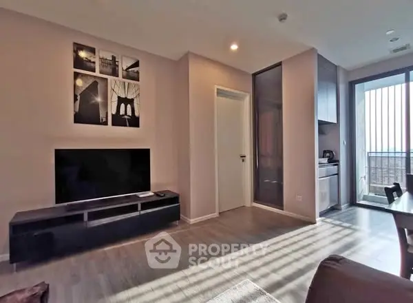 Modern living room with sleek TV setup and balcony view