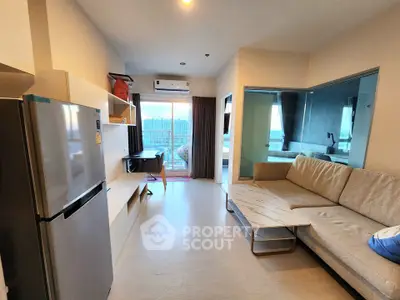 Modern living room with balcony view, featuring sleek furniture and open layout.