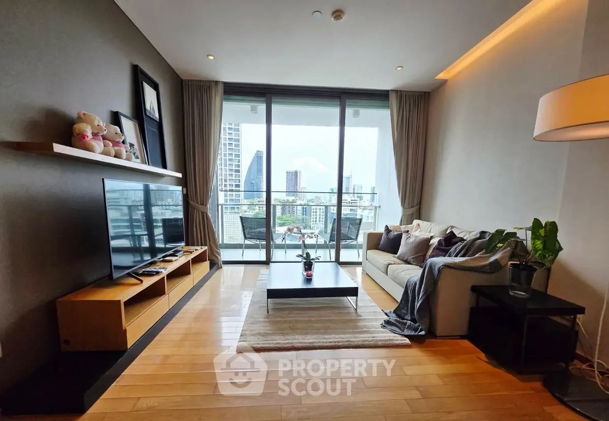 Modern living room with city view, stylish decor, and spacious balcony access.