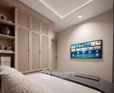 Modern bedroom with wall-mounted TV and stylish storage cabinets