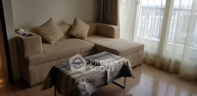 Cozy living room with modern sofa and city view through large windows.