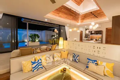 Luxurious open-plan living room with modern decor and pool view, perfect for entertaining.