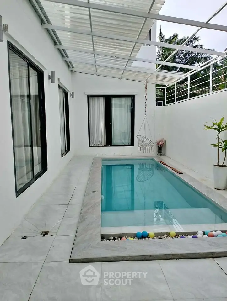 Chic modern home with sleek pool and stylish patio area, perfect for relaxation and entertaining.