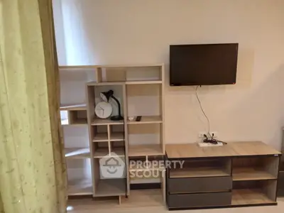 Modern living room with stylish shelving and wall-mounted TV, perfect for contemporary living.