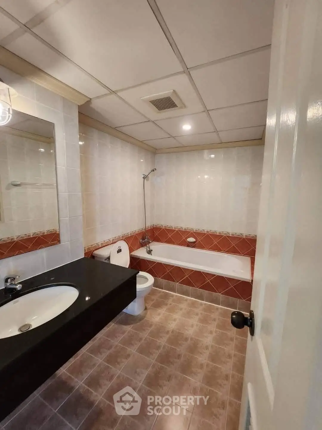 Spacious bathroom with bathtub and modern fixtures in a stylish home.