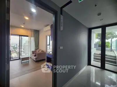 Modern apartment entrance with cozy living room and city view balcony