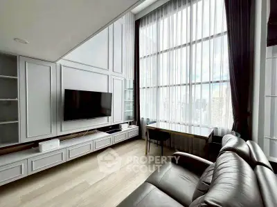 Luxurious high-ceiling living room with city view and modern furnishings.