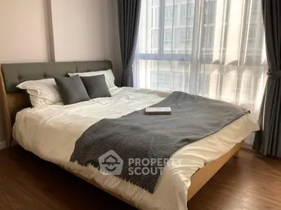 Cozy bedroom with large window and modern decor in urban apartment