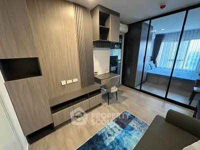 Modern living room with stylish wood paneling and glass partition leading to bedroom