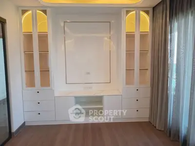 Modern living room with built-in shelves and elegant lighting