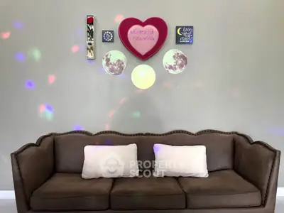 Stylish living room with cozy brown sofa and decorative wall art, perfect for relaxation.
