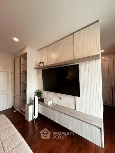 Modern living room with sleek TV unit and wooden flooring
