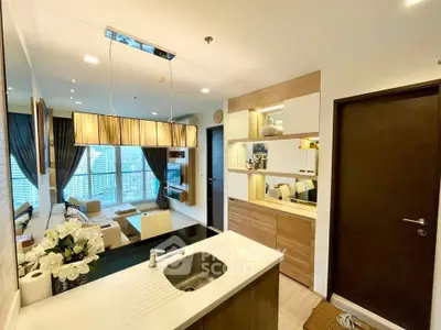 Modern open-layout living room with city view and stylish kitchen