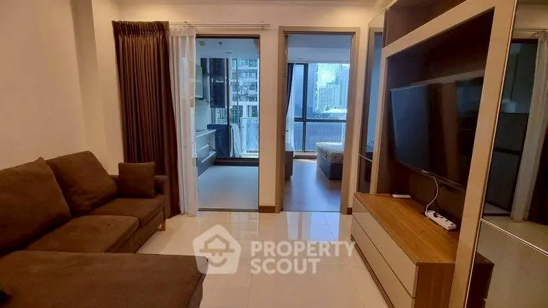 Modern living room with sleek furniture and city view balcony