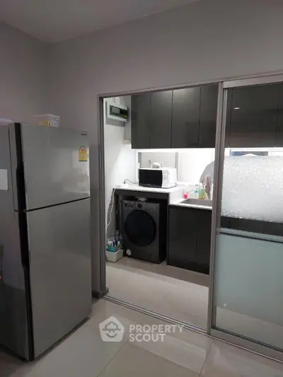 Modern kitchen with sleek appliances and ample storage space