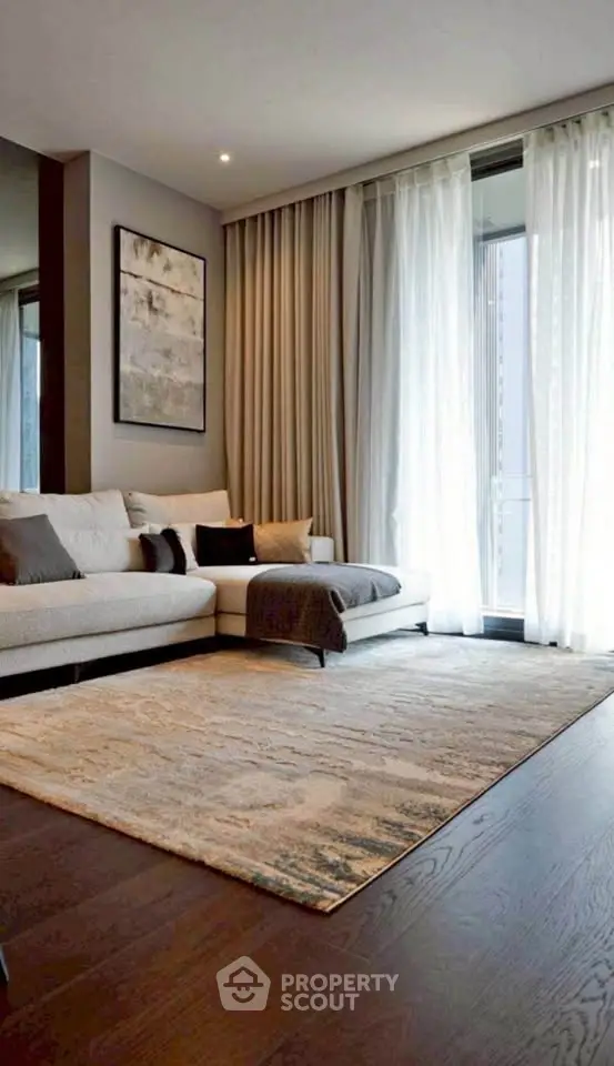 Elegant living room with modern decor, large windows, and cozy seating area.