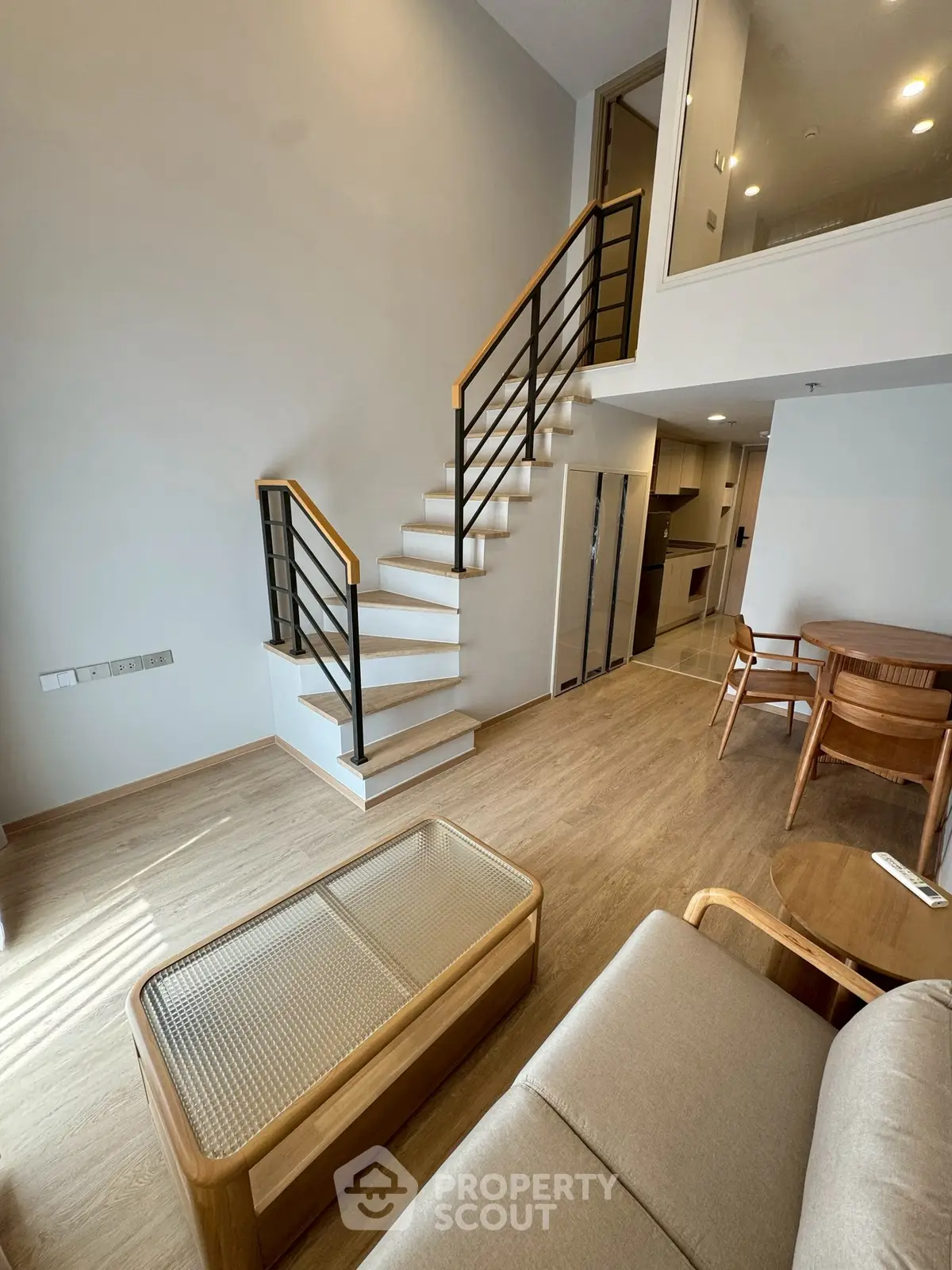 Modern duplex living room with wooden staircase and stylish furniture