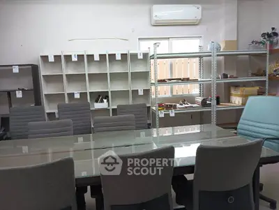 Spacious office room with modern furniture and ample shelving