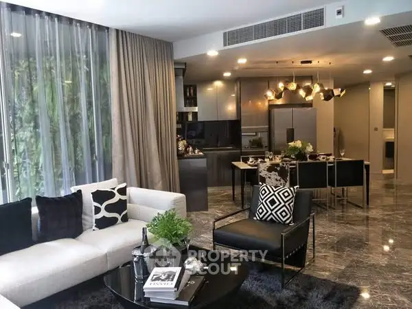 Luxurious modern living room with open kitchen, stylish decor, and elegant lighting.