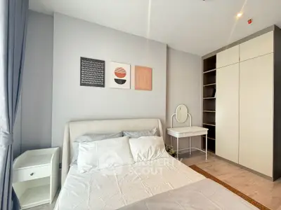 Modern bedroom with stylish decor, featuring a cozy bed, elegant wardrobe, and a chic vanity desk.