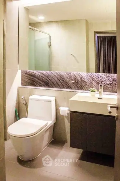 Modern bathroom with sleek design and contemporary fixtures in a stylish apartment.