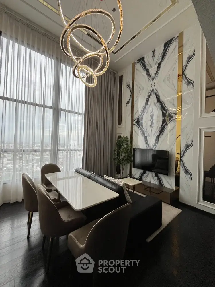 Luxurious modern living room with high ceilings and elegant chandelier