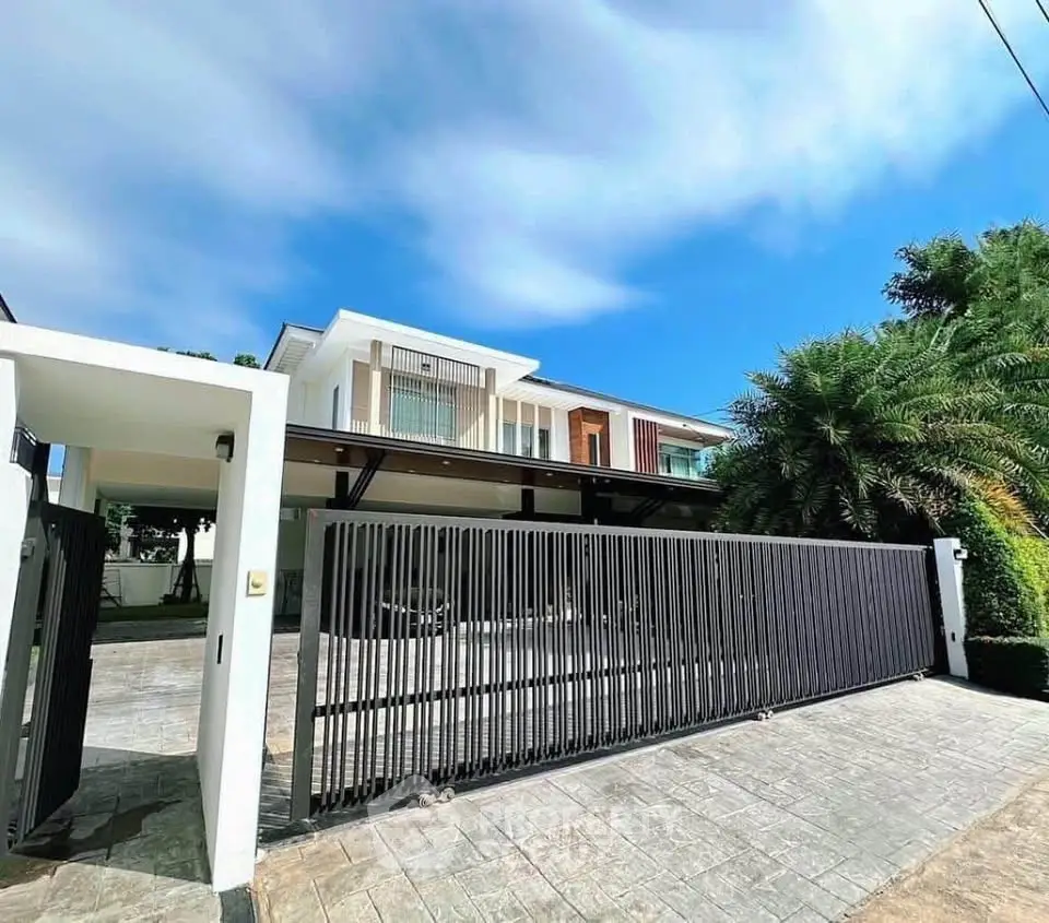 Luxurious modern house with sleek design and spacious driveway in a serene neighborhood.