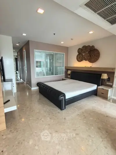 Spacious modern bedroom with stylish decor and large bed