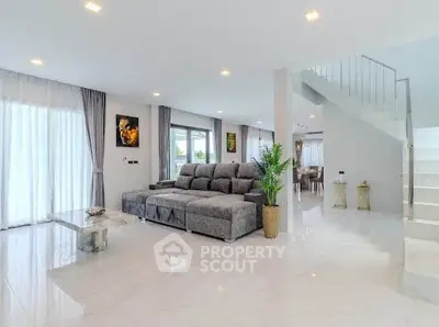 Spacious modern living room with elegant decor and abundant natural light