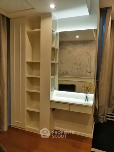 Elegant bedroom corner with built-in shelves and vanity mirror, perfect for stylish storage and decor.