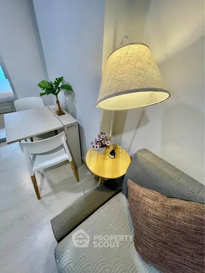 Modern living room with stylish decor, cozy sofa, and elegant dining area, perfect for urban living.