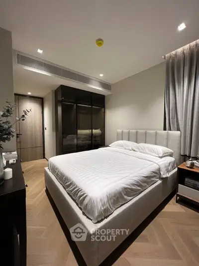 Modern bedroom with sleek design, featuring a comfortable bed and stylish decor, perfect for relaxation.