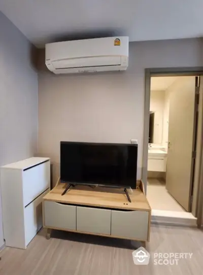 Modern living room with sleek TV stand and air conditioning unit