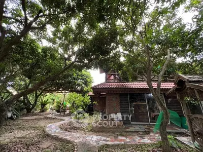 Charming rustic house surrounded by lush greenery and a winding stone path, perfect for nature lovers.