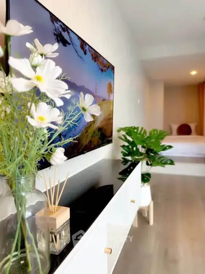 Stylish modern living room with elegant decor and vibrant greenery, perfect for relaxation and comfort.