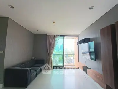 Spacious living room with modern decor and city view balcony.