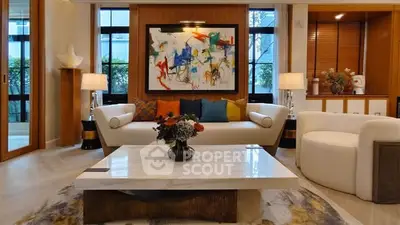 Luxurious living room with modern art, elegant furniture, and natural light.