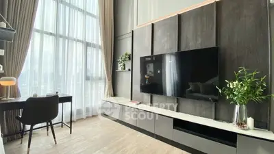 Modern living room with high ceilings, large windows, and stylish decor