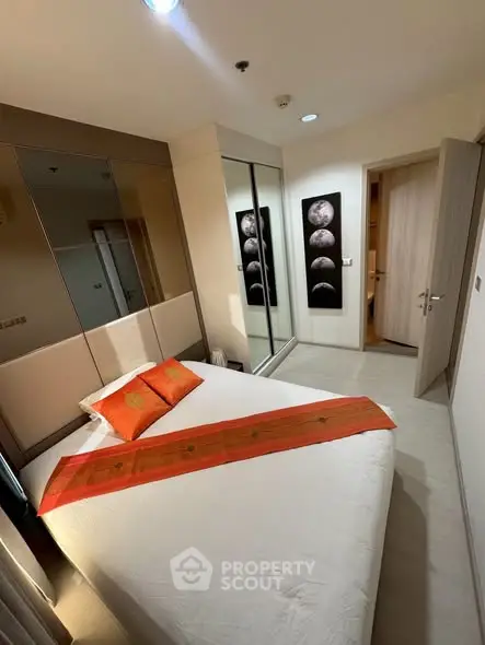 Cozy bedroom with modern decor and mirrored wardrobe