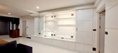 Spacious modern living room with sleek built-in storage and elegant lighting.