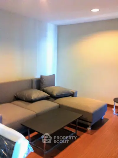 Cozy living room with modern gray sofa and sleek coffee table