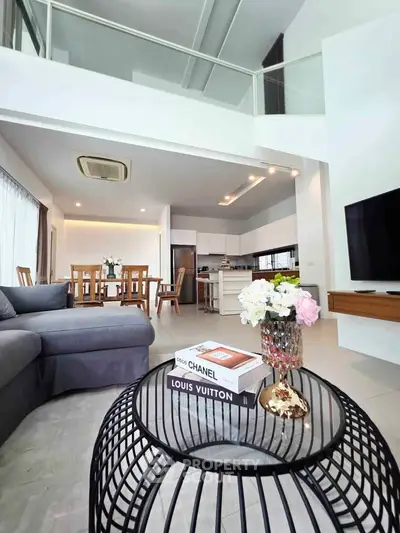 Spacious modern living room with open kitchen and elegant decor in luxury apartment.