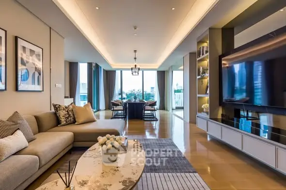 Luxurious open-plan living room with modern decor and large TV