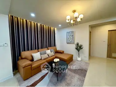 Stylish living room with modern decor, featuring a cozy brown sofa and elegant lighting.