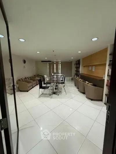 Spacious modern living room with elegant seating and dining area, perfect for entertaining guests.