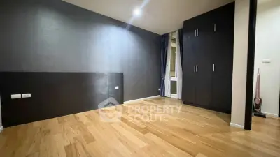 Spacious empty room with wooden flooring and built-in wardrobe, perfect for customization.