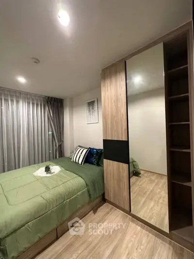 Modern bedroom with stylish decor and spacious wardrobe in a cozy apartment.