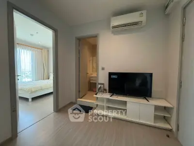 Modern apartment interior with bedroom and living area featuring air conditioning and TV setup.